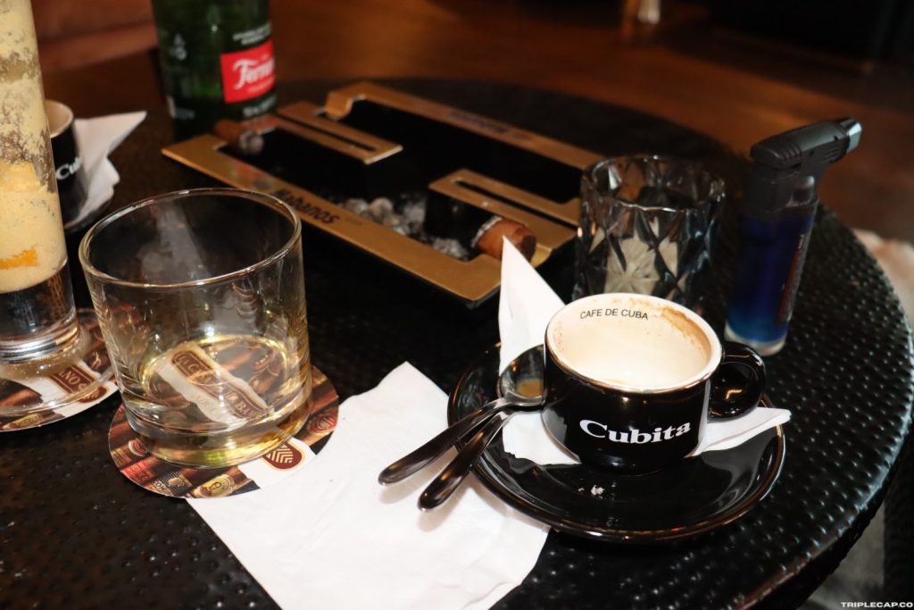 The remnants of a Mojito and a Cuban coffee. The nub of a H Upmann Mag 54 and a Trinidad Reyes in the background.